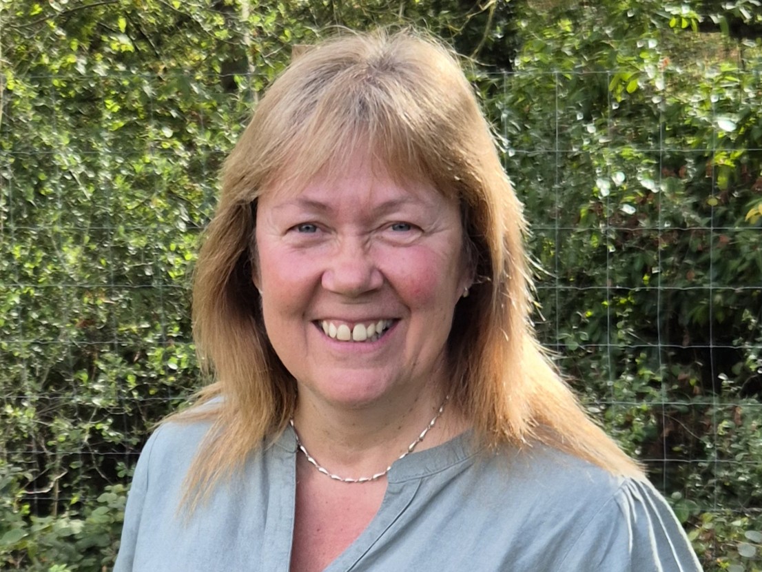Photo of Sue Smith Marden Parish Council Deputy Clerk standing in front of a head